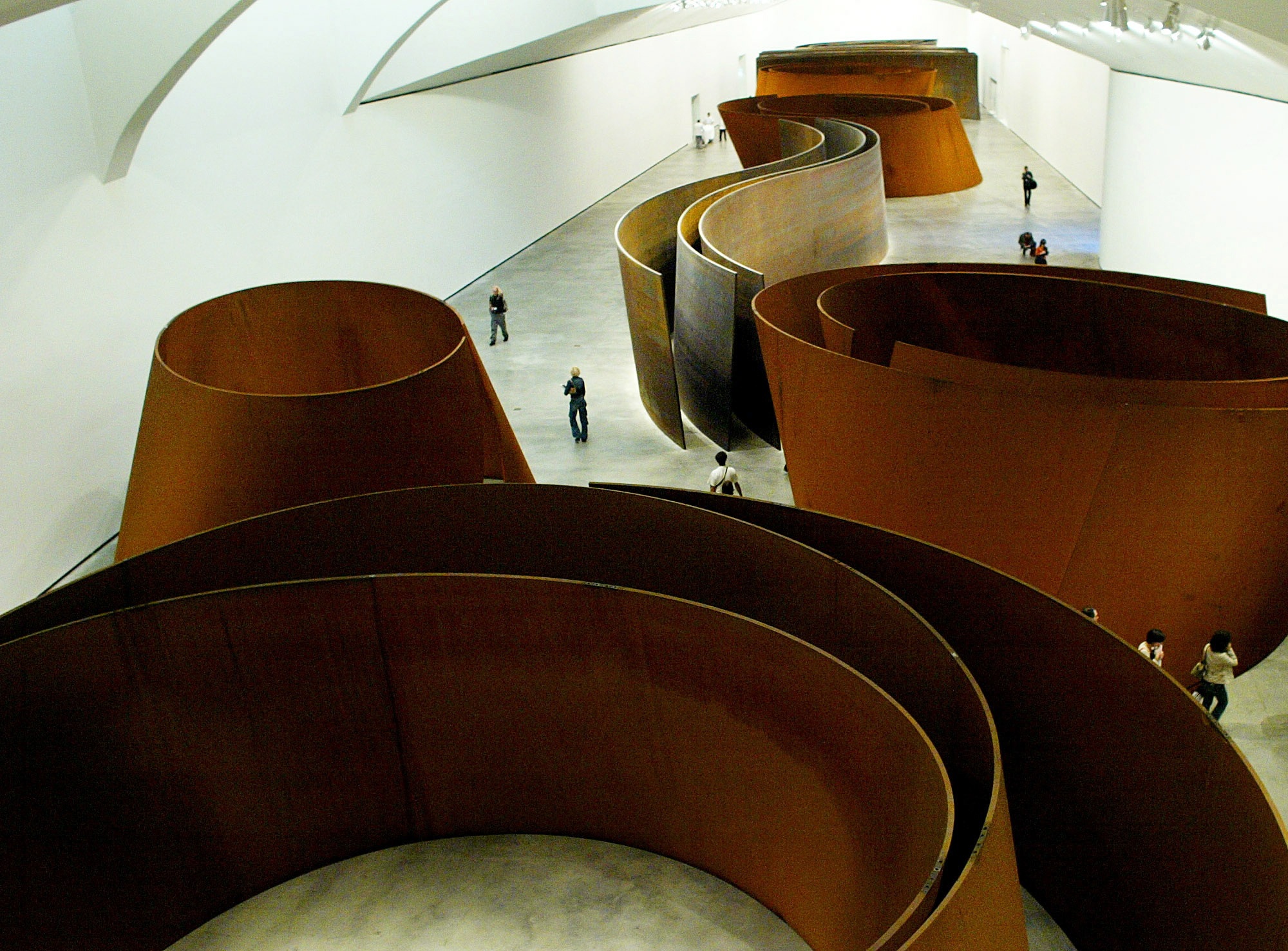 Visitors Observe Eight Massive Steel Sculptures By U.s. Artist Richard Serra During A Special Previe..